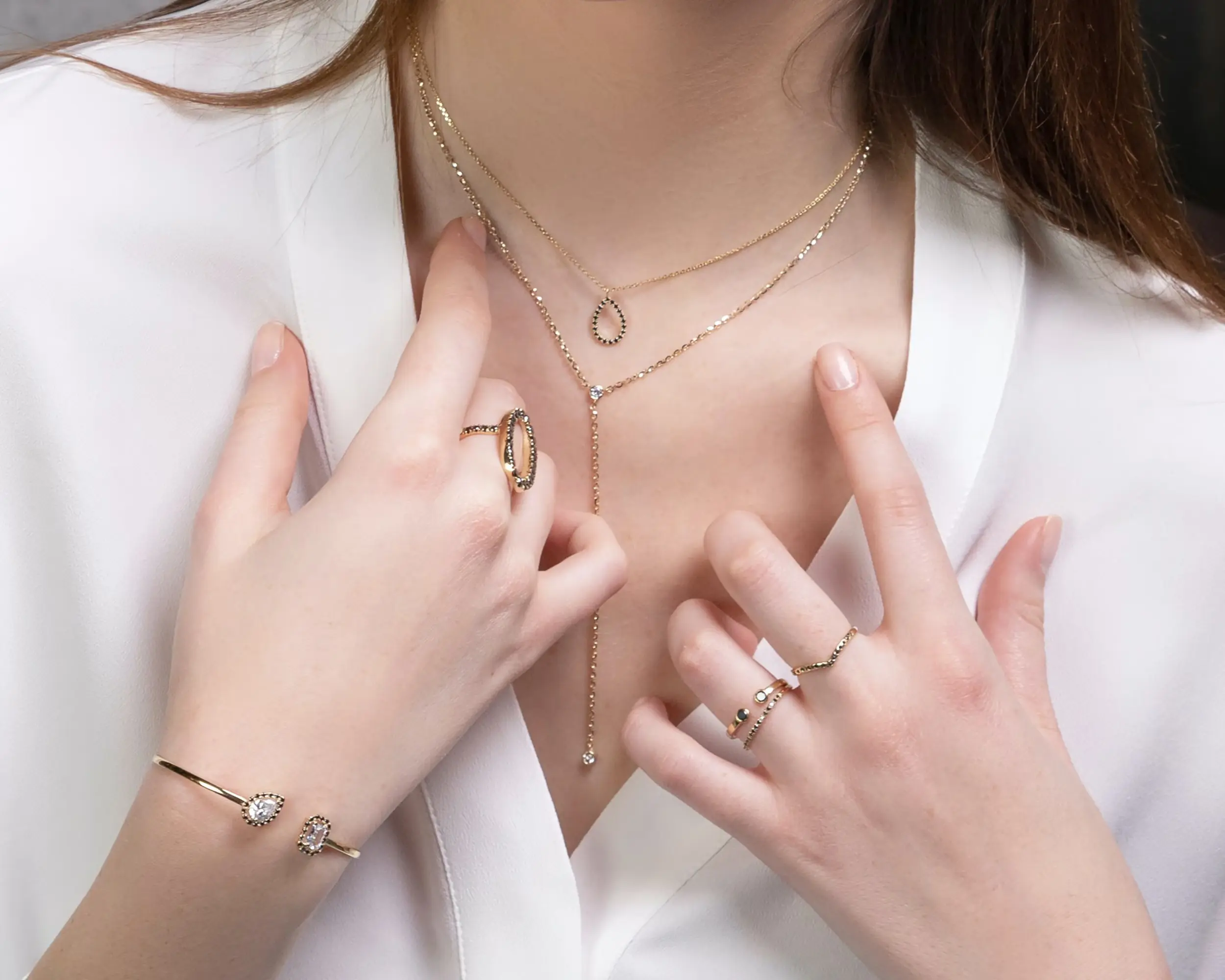 Model wearing Jewelry including necklace, rings bracelet, and pendant set